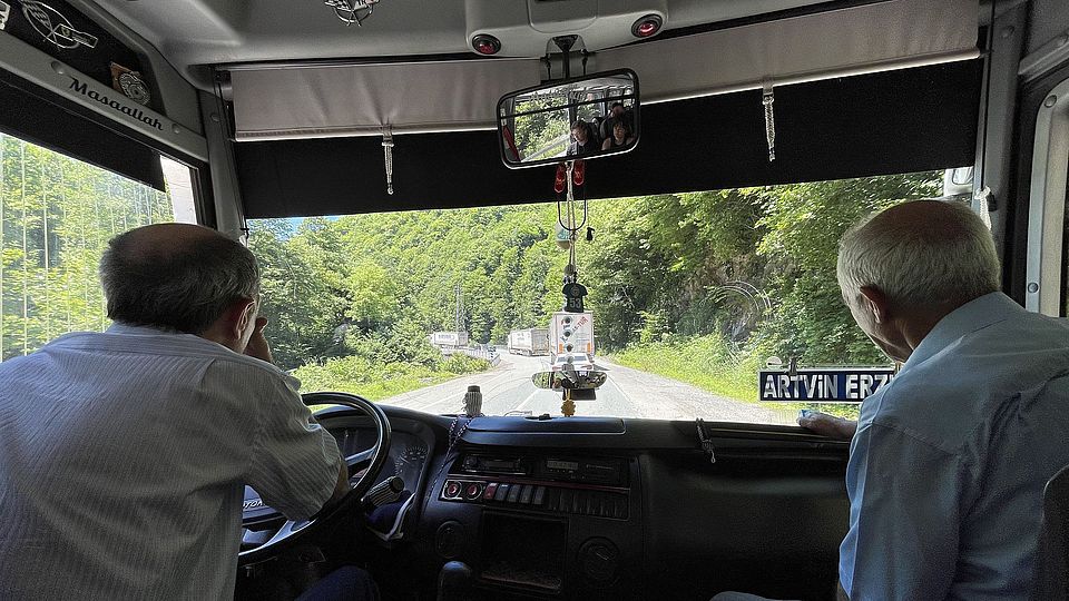 Busdrivers from behind, looking out of the front window